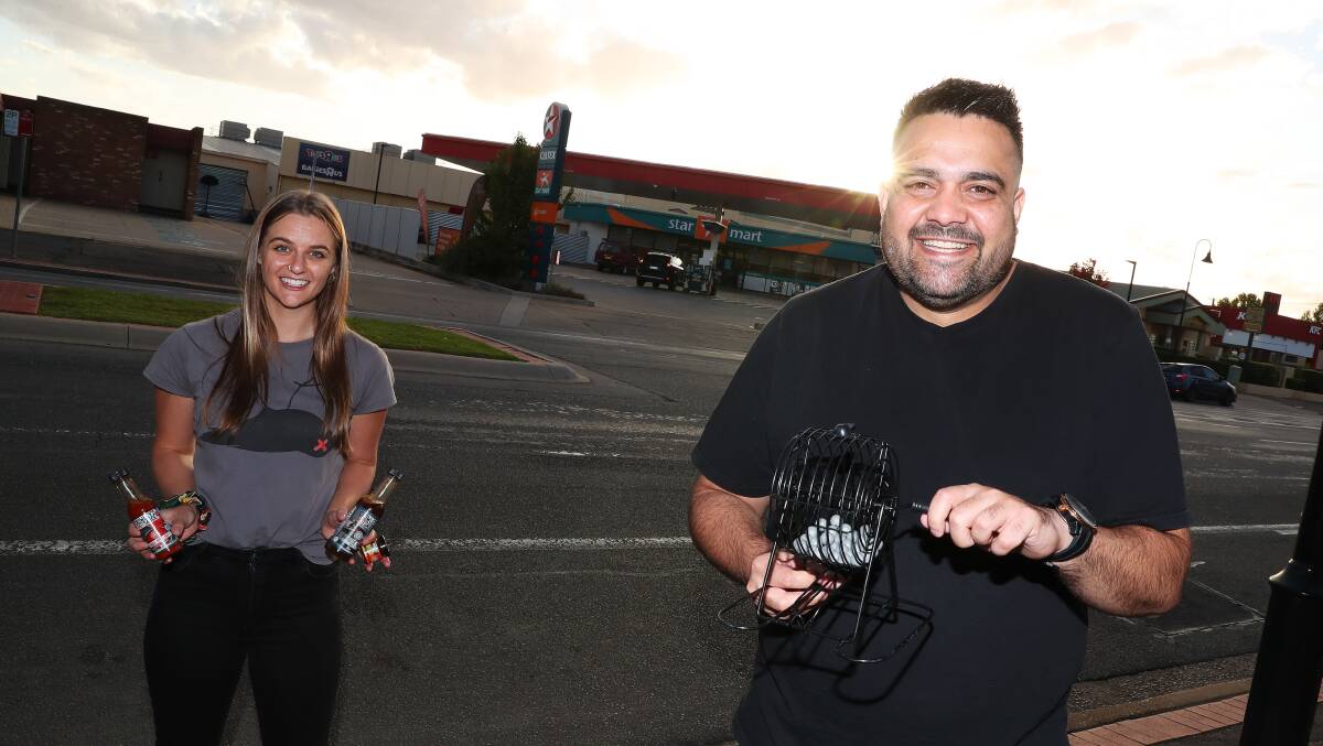 HOME ENTERTAINMENT: Comedian Dane Simpson prepares to host Servo Bingo, as Thirsty Crow's Katie Galvin prepares the sauces for the hot wing challenge. Picture: Emma Hillier