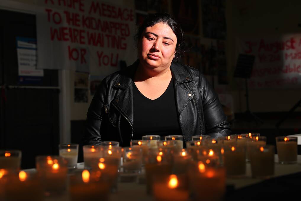REMEMBRANCE: Khatom Altamar observes candles lit in tribute to those killed and kidnapped on August 3 2014. Picture: Emma Hillier.