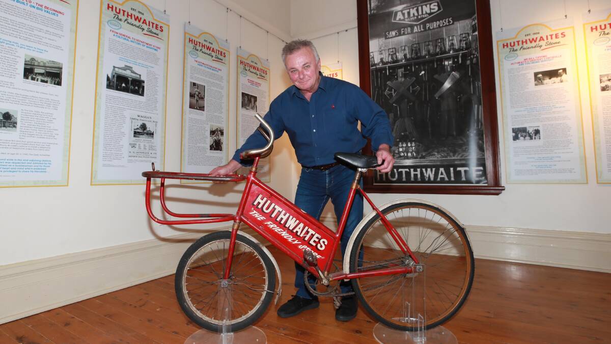 HISTORY: From this little red bicycle, pictured with museum manager Luke Grealy, came a flood of memories of a beloved Wagga business. Picture: Les Smith