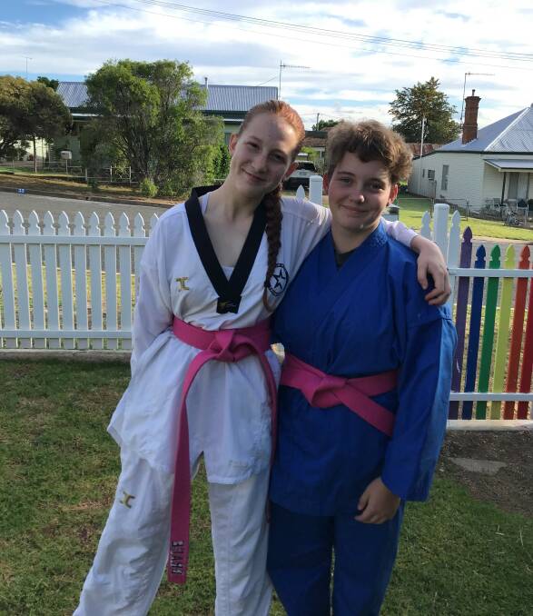 SHARING STORIES: Grace Sanders, 14, and the recipient of her Taekwondo scholarship Jazmin Ross, 14, at a meet-up in Junee. Picture: Contributed