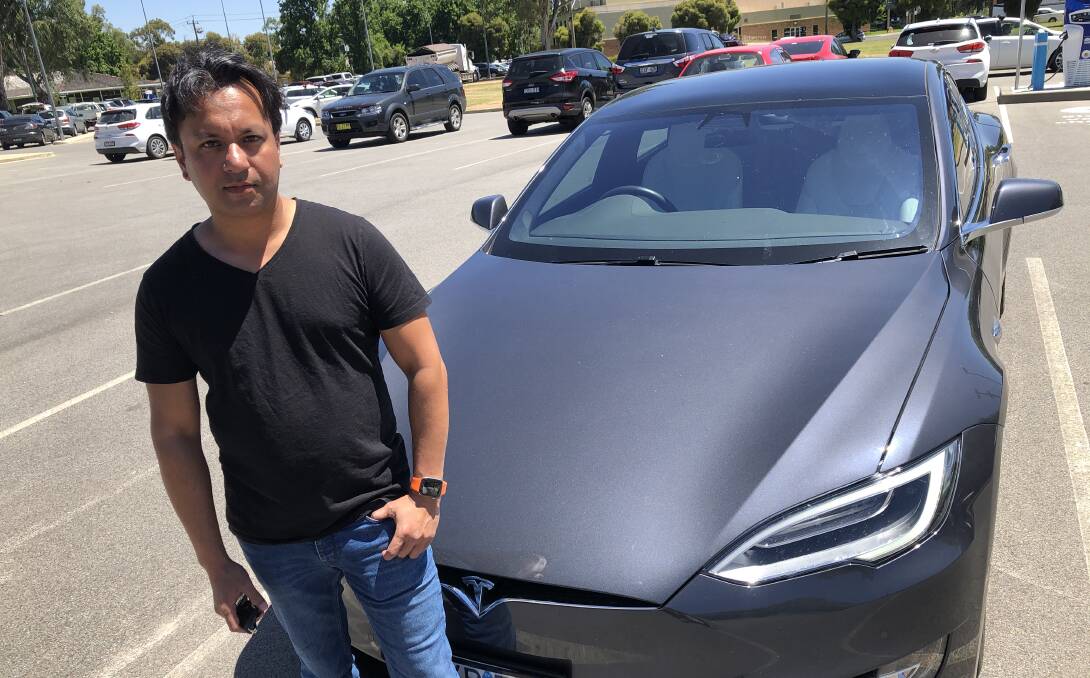 EARLY ADOPTER: Dev Mukherjee uses his Tesla like any family vehicle, but without the trips to the petrol station. Picture: Rachel McDonald
