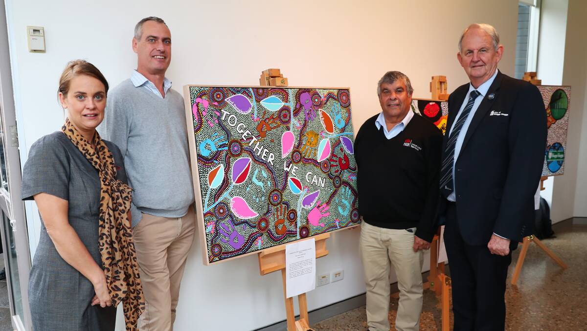 POSTPONED: Leanne Sanders, Rob Kelly, Greg Packer and Greg Conkey with an art piece created as part of last year's NAIDOC Week celebrations.