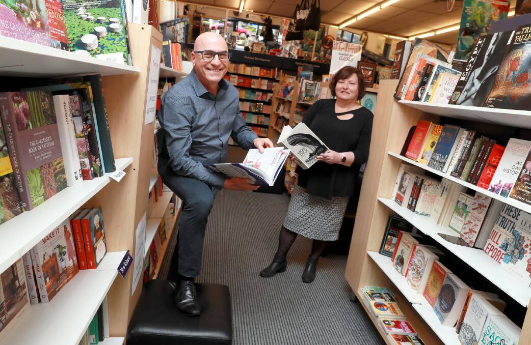 CHANGING HANDS: Departing Collins Booksellers owner Peter Halicki with new owner Jenny Leggett. Picture: Les Smith