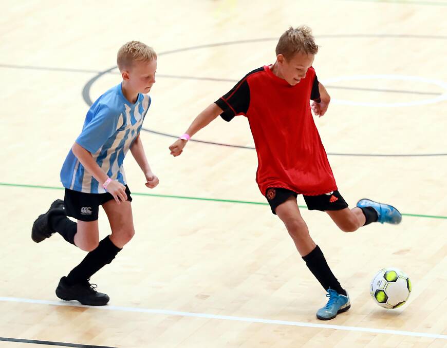 CHASE: Kobi McCallum and Bill Bittar face off in the under 10s at the Wagga Futsal Cup on Sunday. Picture: Les Smith
