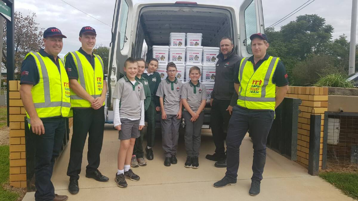 HELPING HAND: Rapid Relief Team volunteers deliver 100 food boxes to Leeton High School on Wednesday. Picture: Contributed