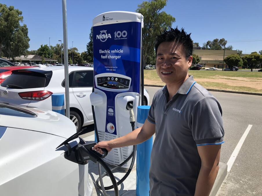 STOPPING BY: Long Nguyen uses the new electric vehicle charger while in Wagga for work. Picture: Rachel McDonald