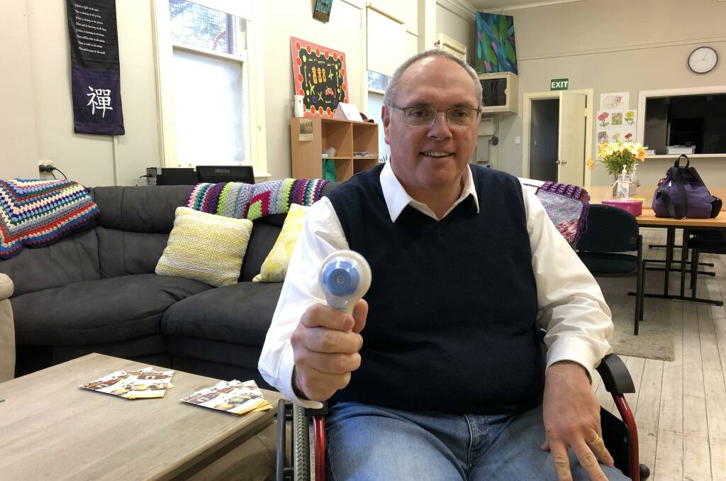 OPEN FOR VISITORS: Sunflower House president Mark Horton with the house's handheld thermometer, part of its new hygiene measures. Picture: Rachel McDonald