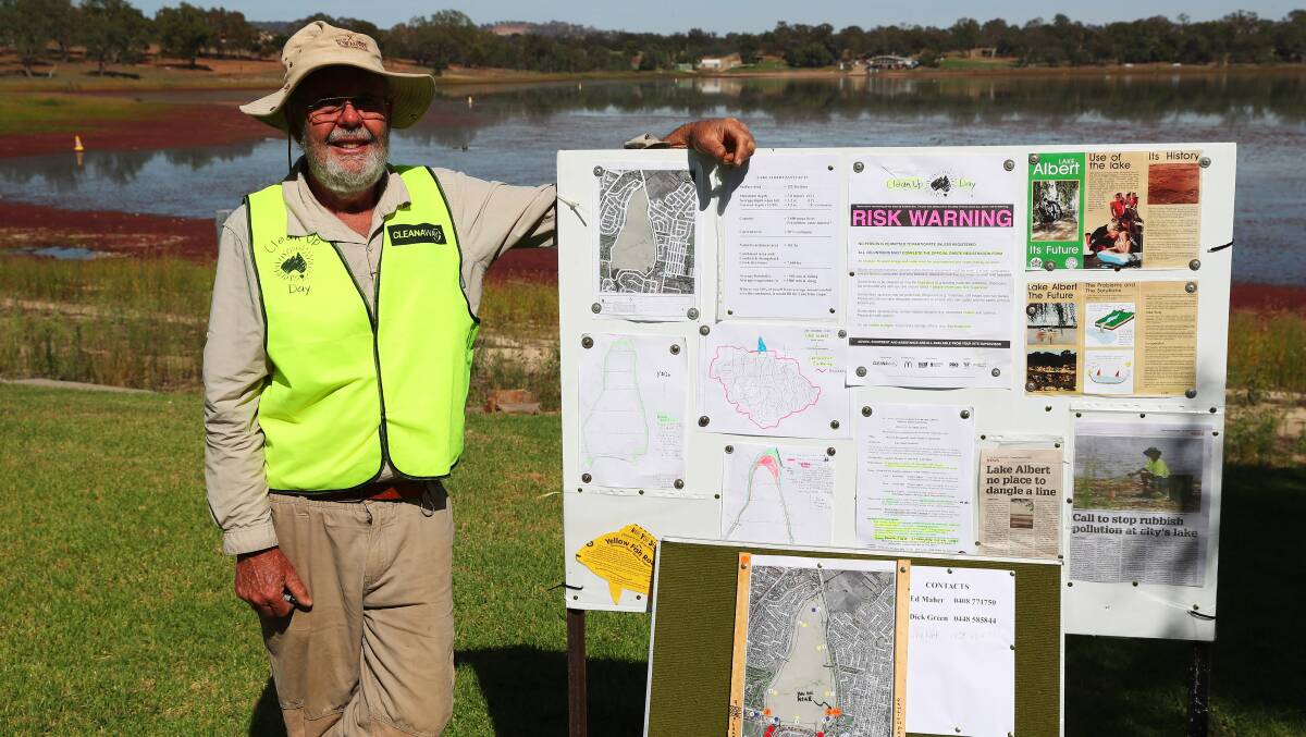 PROTECT THE LAKE: Dick Green from the Wagga Urban Landcare Group directs volunteer efforts to clean up Lake Albert. Picture: Emma Hillier