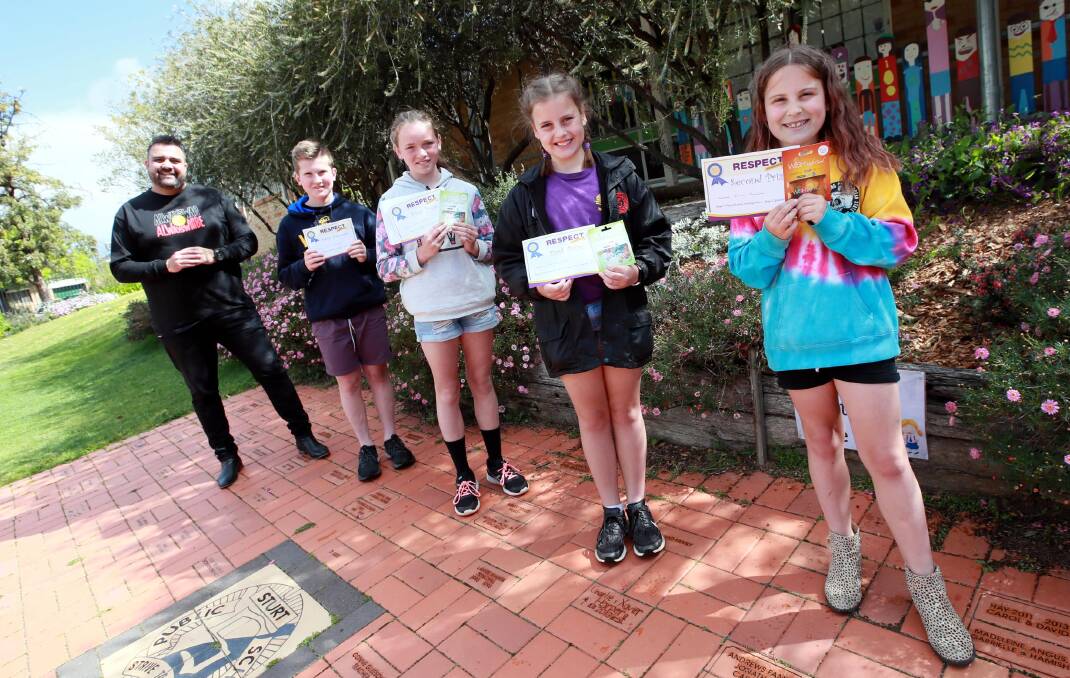 WINNERS: Dane Simpson presented Sturt Public School's Archie Keough, 11, Lucy Anderson, 12, Claire Sutton, 10 and Emma Leonard, 8 with their awards. Absent was Yusen Li of Wagga Christian College. Picture: Les Smith 