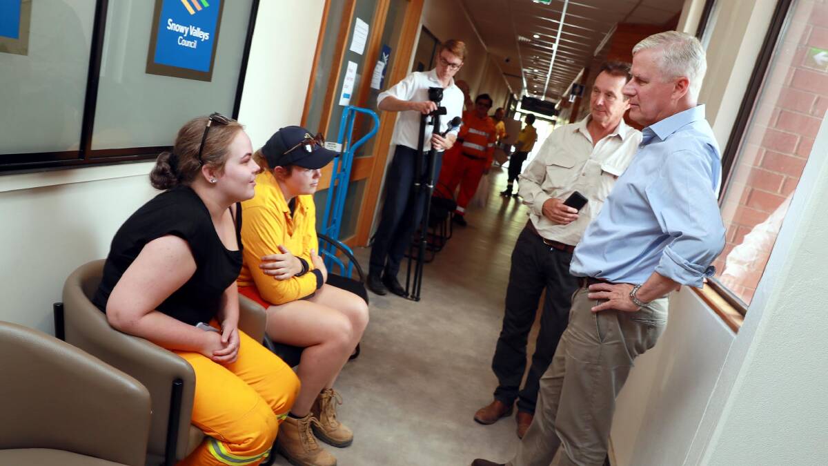 Michael McCormack and Snowy Valleys mayor James Hayes chat with Adelong RFS volunteers Bec Dean and Mia Hardwick