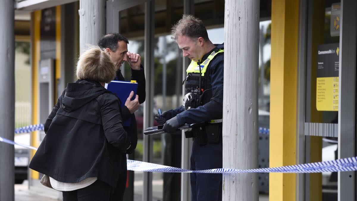 Police conduct interviews out the front of a Commonwealth Bank on Tuesday after an alleged robbery on Tuesday. Photo: Adam Trafford.