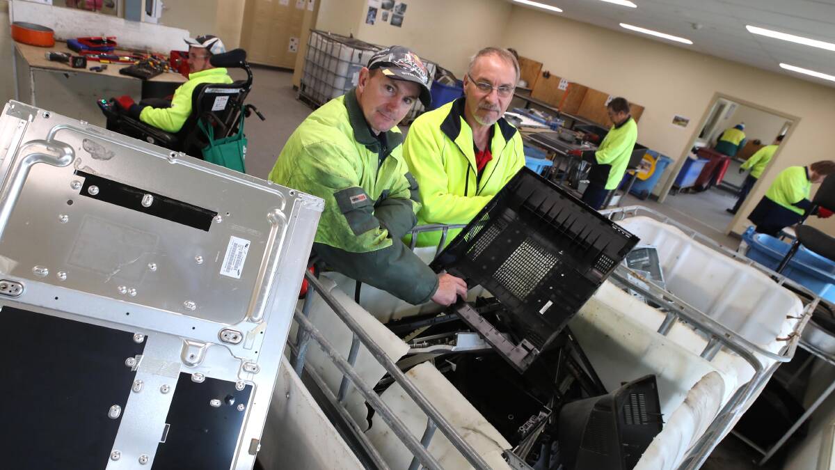 PROCESSING: Kurrajong Recycling e-waste senior supervisor Doug Brambley and depot senior supervisor Ron Butler with old electronics handed in to Wagga City Council to be stripped of valuable materials. Picture: Les Smith
