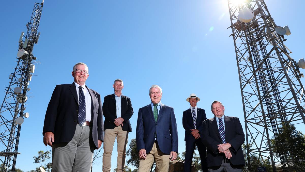 Federal Regional Communications Minister Mark Coulton, Hilltops mayor Brian Ingram, Riverina MP Michael McCormack, Snowy Valleys mayor James Hayes and Cootamundra-Gundagai mayor Abb McAlister and the announcement of mobile and internet blackspot grants on top of Willans Hill at Wagga on Friday. Picture: Emma Hillier 