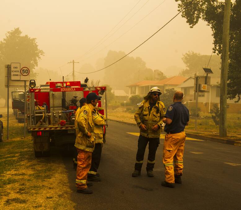 INQUIRY: The Rural Fire Service in Batlow last month when the town was under threat from the Dunns Road bushfire. Picture: Dion Georgopoulos