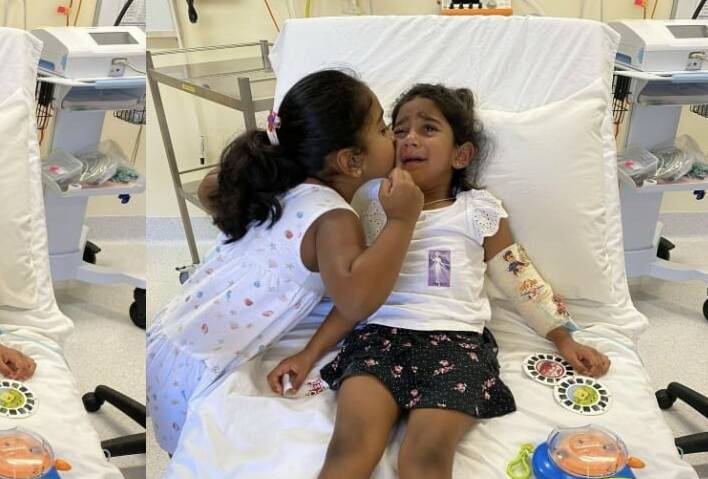 Kopika Muruguppan, age 6, comforts her sister Tharnicaa, aged 4, while receiving medical care in immigration detention. Riverina MP Michael McCormack passed on a letter in support of the family staying in Australia to the Immigration Minister in 2019. Picture: Home to Bilo campaign. 