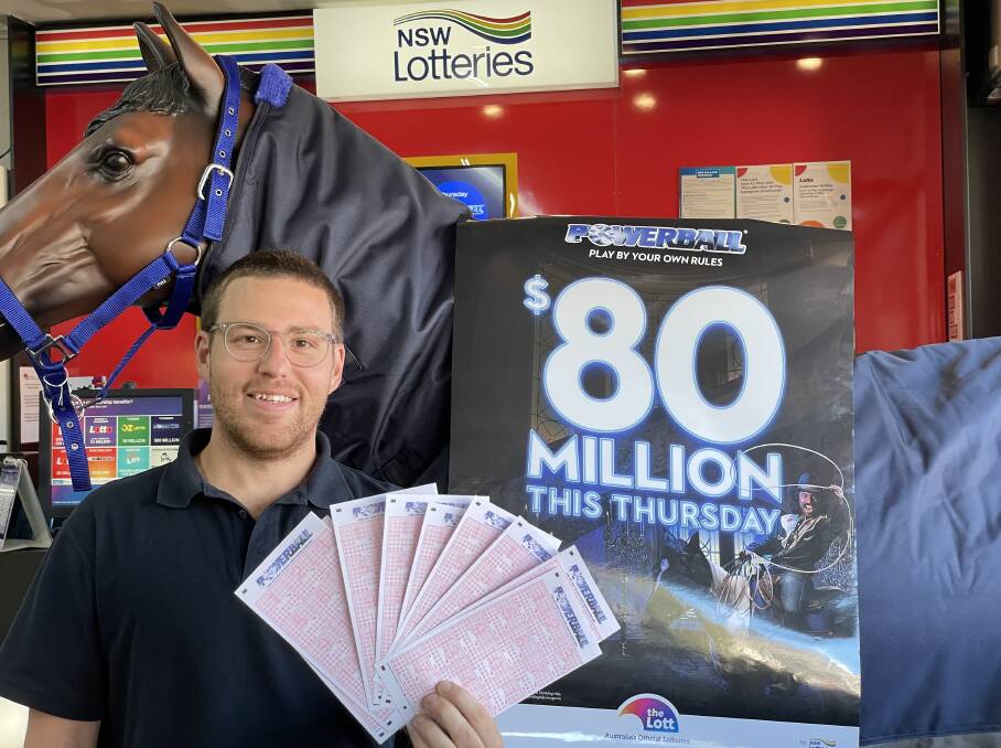 HUGE PRIZE: Hunters newsagent staff member Simon Azzopardi with tickets for Thursday's $80 million Powerball lottery draw. Picture: Rex Martinich