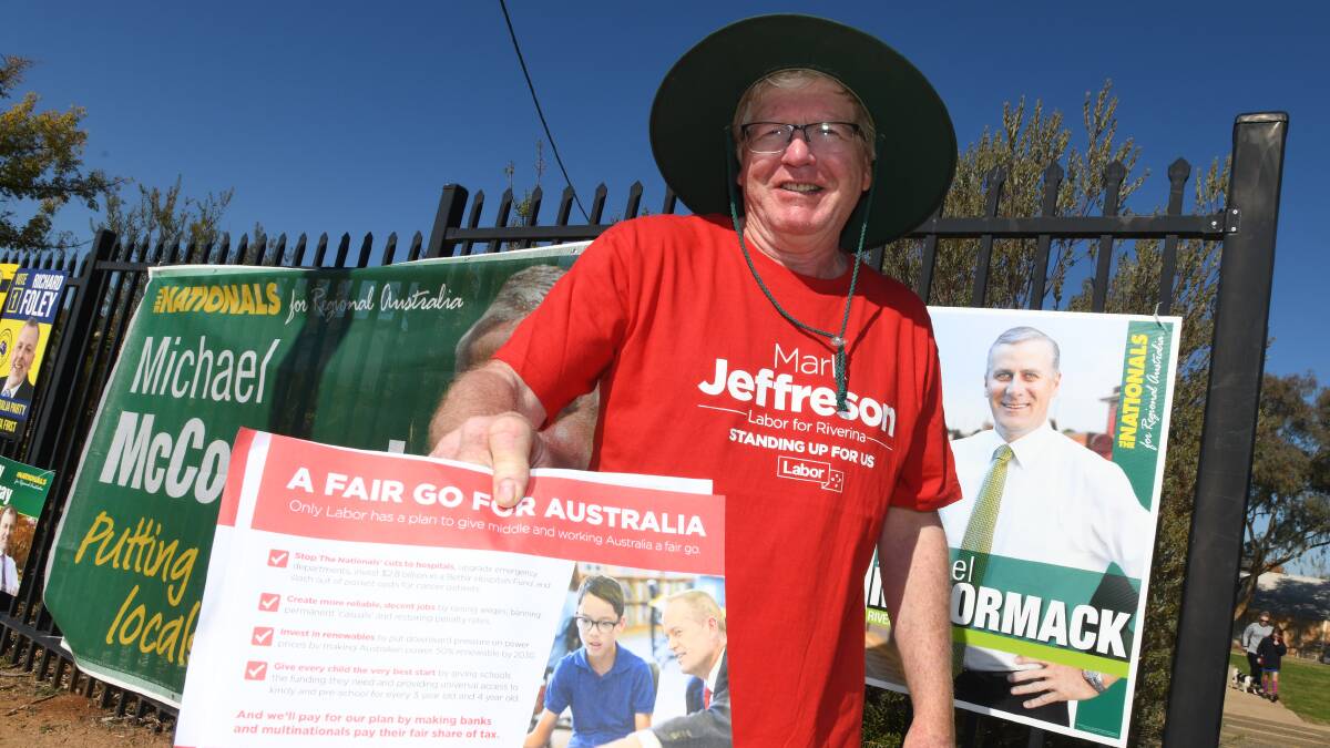 Steve Cord hands out how-to-vote cards in Wagga for the federal election on Saturday.
