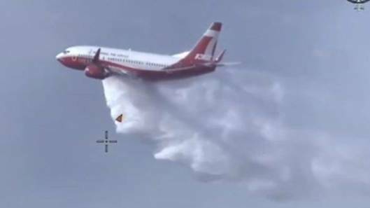 A 737 Large Air Tanker in action against fires at Port Stephens last month. The same model aircraft was deployed on Sunday to the Dunns Road bushfire between Tarcutta and Adelong. 