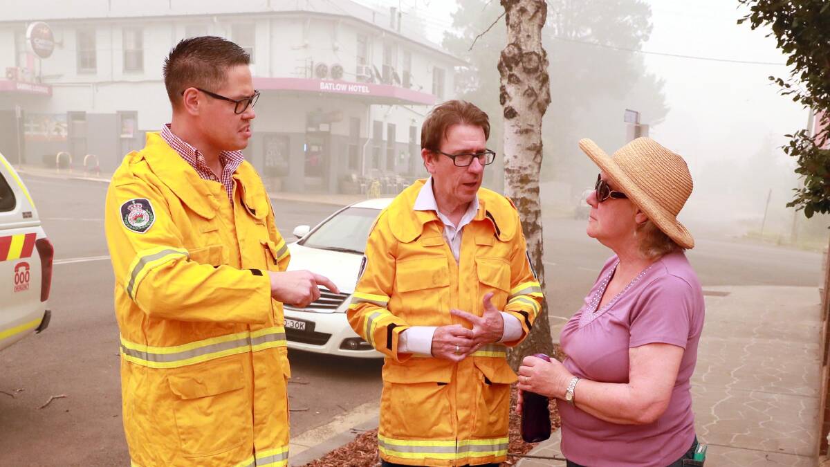 DAMAGE: Wagga MP Joe McGirr and MLC Wes Fang chat with Snowy Valleys councillor Margaret Isselmann in Batlow. Dr McGirr has called for investigation into whether the Dunns Road fire could have been stopped early. 