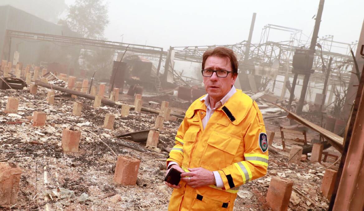 Wagga MP Joe McGirr surveys the complete destruction to the remaining part of the old Mountain Maid cannery in Batlow in January. Dr McGirr has said raising council rates without other tax relief will not help bushfire-hit regions.