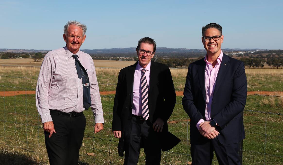 Wagga mayor Greg Conkey, Wagga MP Joe McGirr and Wagga-based Nationals MLC Wes Fang in front of the paddocks at Bomen that will become a new industrial zone via the special activation precinct. Picture: Emma Hillier 
