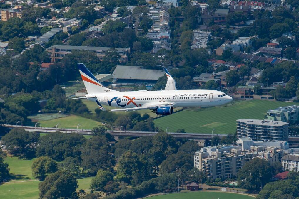 One of Region Express's new Boeing 737 aircraft in flight over Sydney in January ahead of the launch of its new domestic capital city services in March. Picture: Regional Express/twitter.