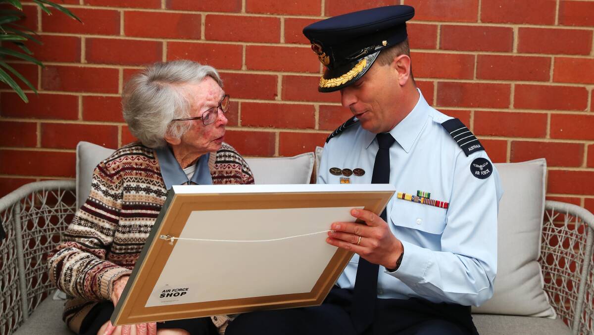 SERVICE: RAAF Wagga Base Group Captain Chris Ellison presents former Women's Auxiliary Australian Air Force member Beryle Barton with a certificate celebrating her shared 100th birthday with the air force. Picture: Emma Hillier