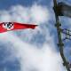 NOW BANNED: A Nazi flag is seen flying from the top of a light tower at Robertson Oval in February 2020. The offensive act partially inspired a new ban on displaying Nazi symbols.