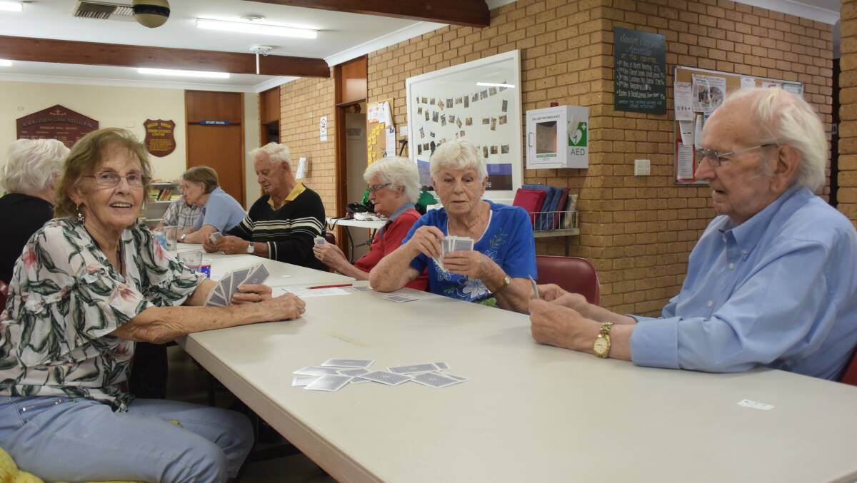 BONUS: Eleanor Grady, Dawn McDermott and Alan Kennedy play cards at Wagga Senior Citizens Centre. Ms McDermott and Mr Kennedy plan to spend their stimulus cash on new shoes, groceries and bills.