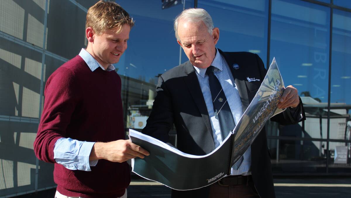 City strategy manager Tristan Kell and mayor Greg Conkey survey the full report into the expansion of the health precinct. Picture: Emma Horn