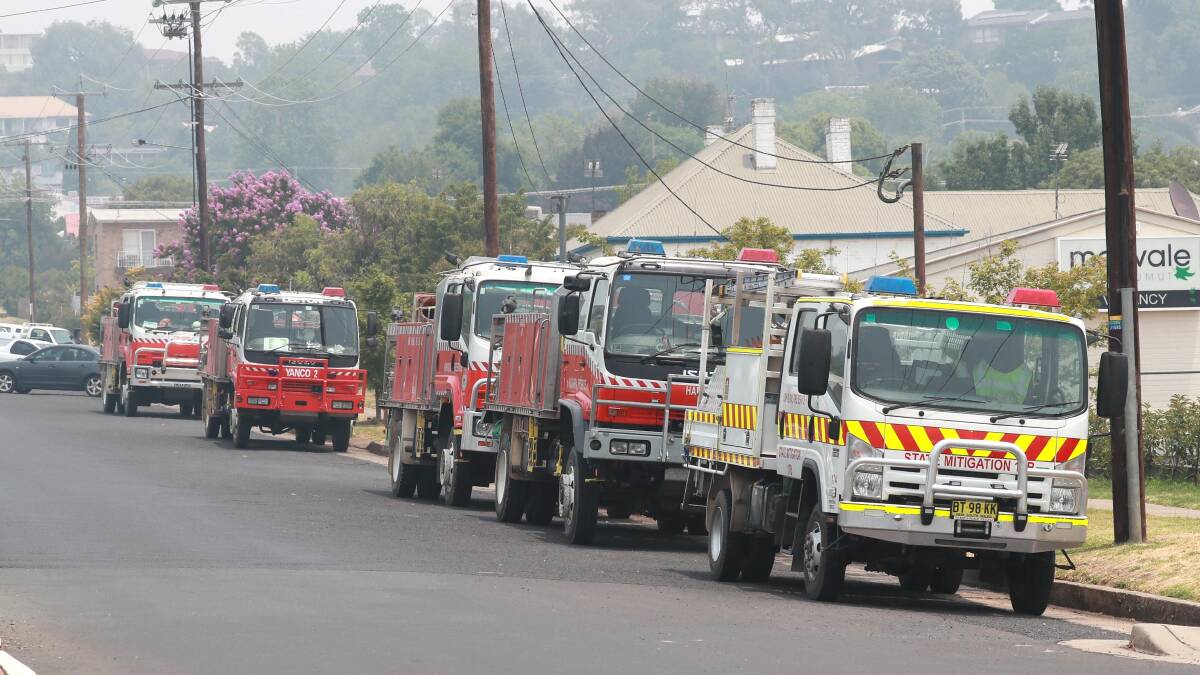 Fire trucks parked in Tumut on Friday morning ahead of extreme fire conditions on Saturday. Picture: Les Smith