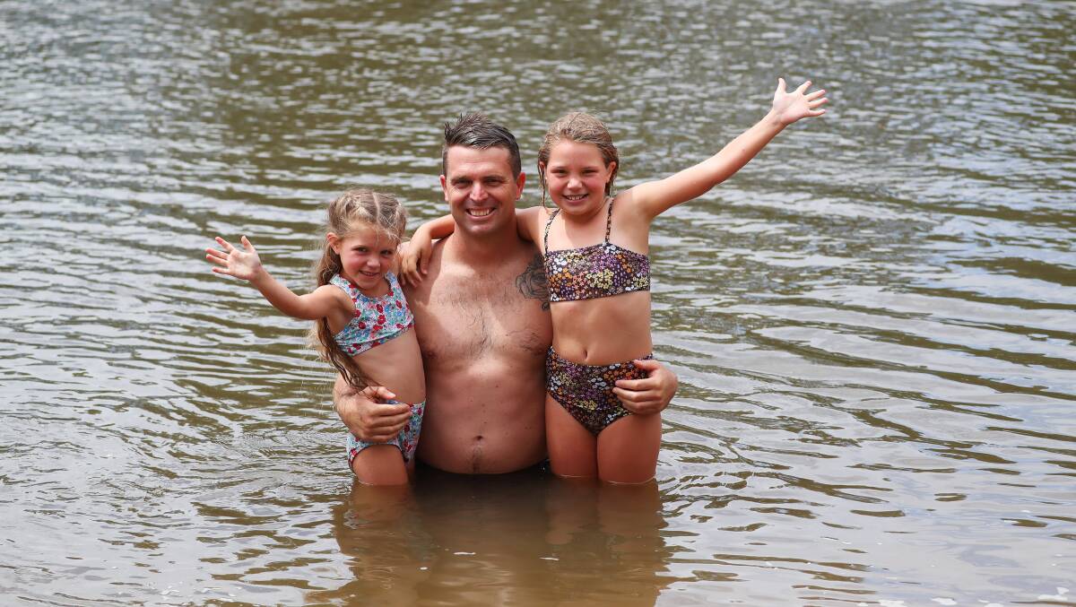 KEEPING SAFE: Georgie, aged 5, Mitch and Charlotte Jones, aged 8, from Wagga were staying safe at Wagga Beach yesterday. Royal Life Saving says the drowning risk doubles on public holidays and has urged people to be cautious in and around the Murrumbidgee River. Pictures: Emma Hillier