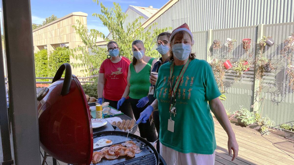 GIVING: St Vincent's worker Shirley Stathopoulos (front) accommodation team leader Bonnie Jackson-French and volunteers Meaghan and Claire Lawlor prepare a Christmas Day breakfast for Wagga's homeless people. Picture: Rex Martinich