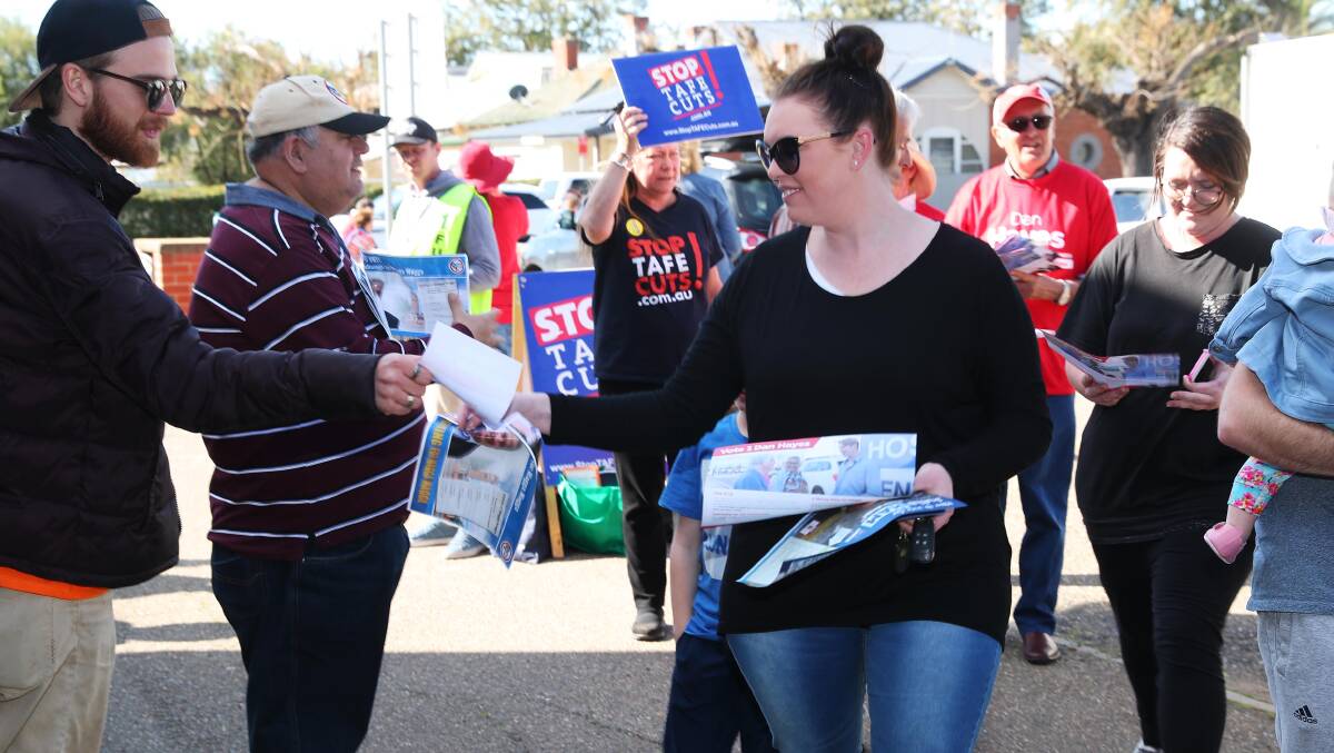 Volunteers hand out how-to-vote cards outside South Wagga Pimary School on Saturday for the Wagga Byelection 2018. Picture: Emma Hillier
