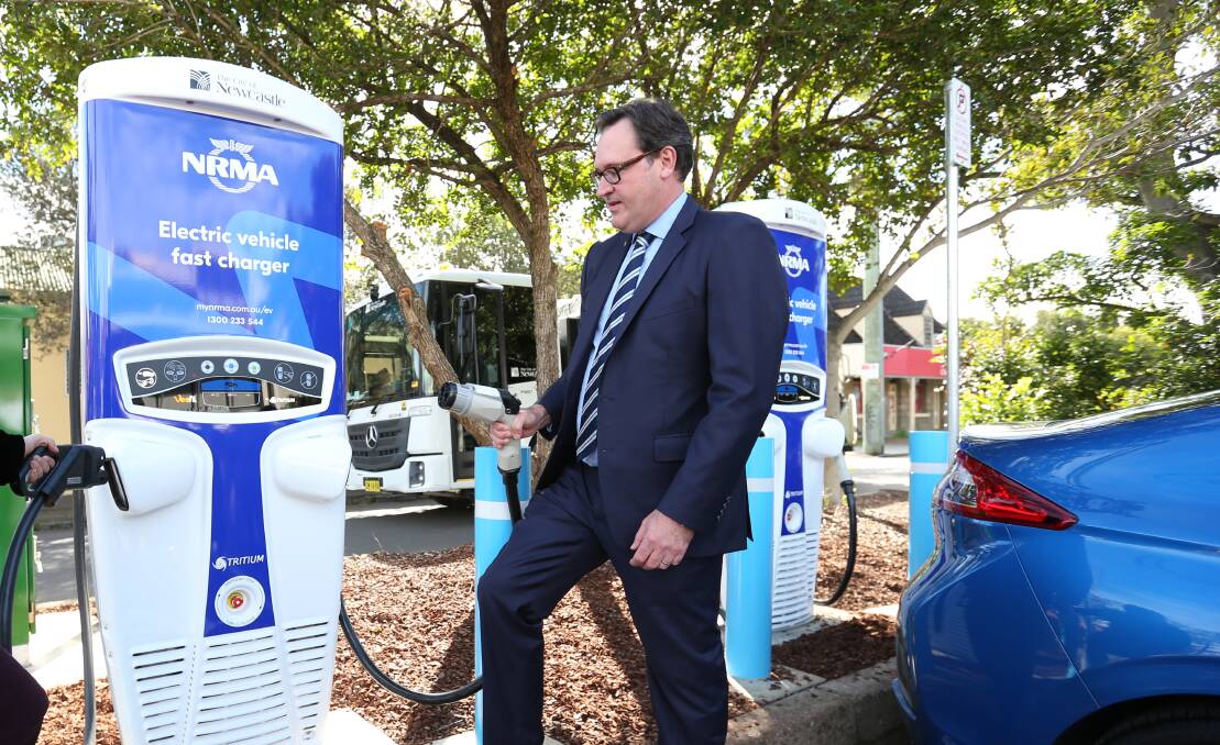 ZAP: NRMA's Michael Gabriel with a 'fast charger' for electric vehicles in Newcastle. A similar charger could be built in Wagga. Picture: Simone De Peak
