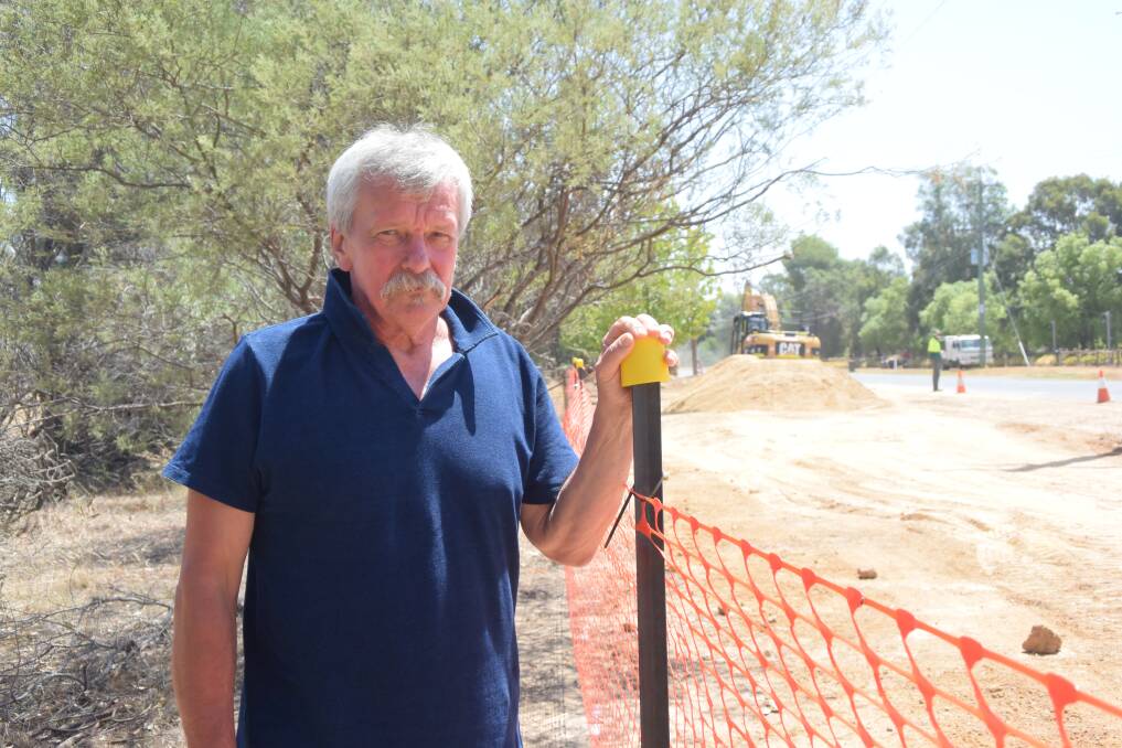 Springvale retiree Tom Zielinski with a temporary fence beside his property. He claims he has been left hundreds of dollars out of pocket due to Wagga City Council's approach to building a new road drain. Picture: Rex Martinich 