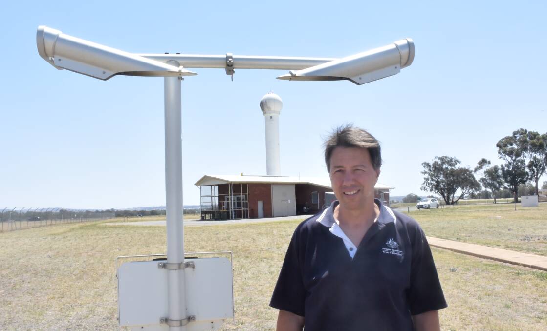 Bureau of Meteorology technical officer Nigel Smedley with the air visibility meter at the Wagga Airport weather station. Picture: REX MARTINICH