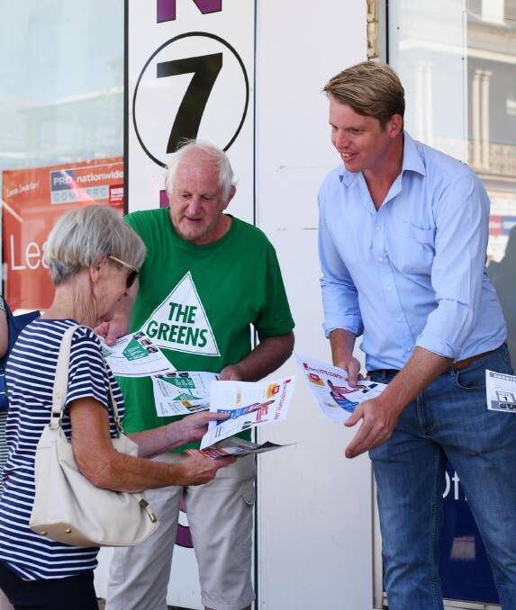 DISTANT THIRD: Wagga Labor candidate Dan Hayes (right) hands out how-to-vote cards for a NSW election campaign that yielded the party's worst result in eight years as independent MP Joe McGirr's primary vote surged. 
