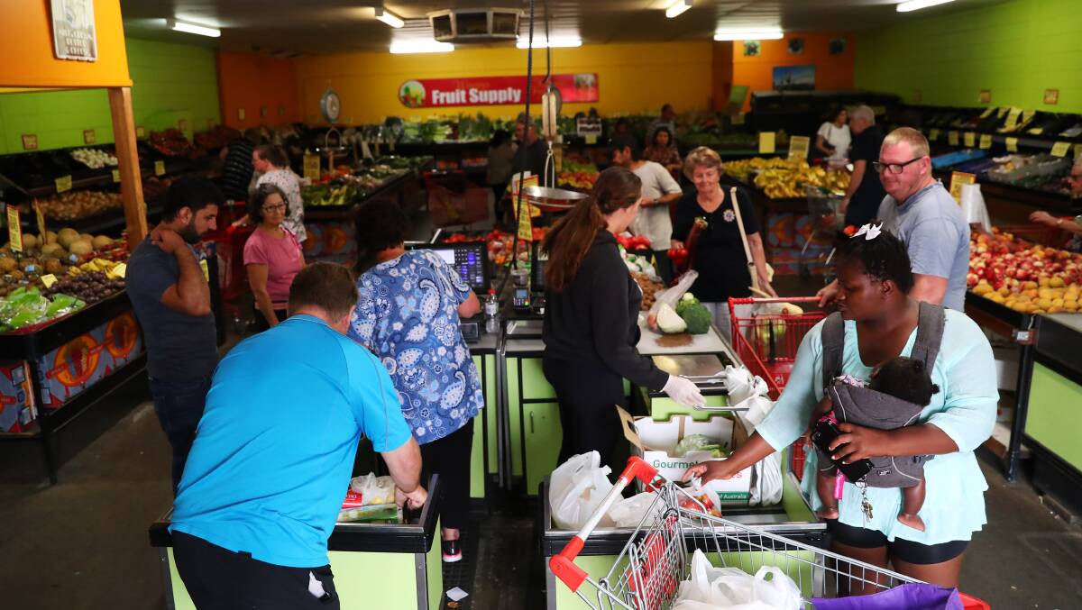 Shoppers stock up at Wagga Fruit Supply on Thursday as coronavirus fears spark a surge in demand for food. Picture: Emma Hillier.