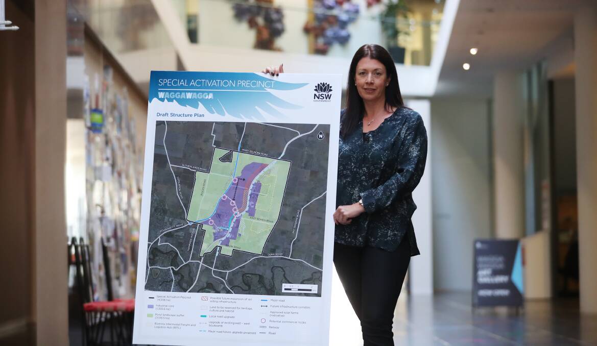 Department of Planning, Industry and Environment executive director for regions, industry and key sites, Anthea Sargeant, with a map of the proposed Wagga Special Activation Plan. Picture: Emma Hillier