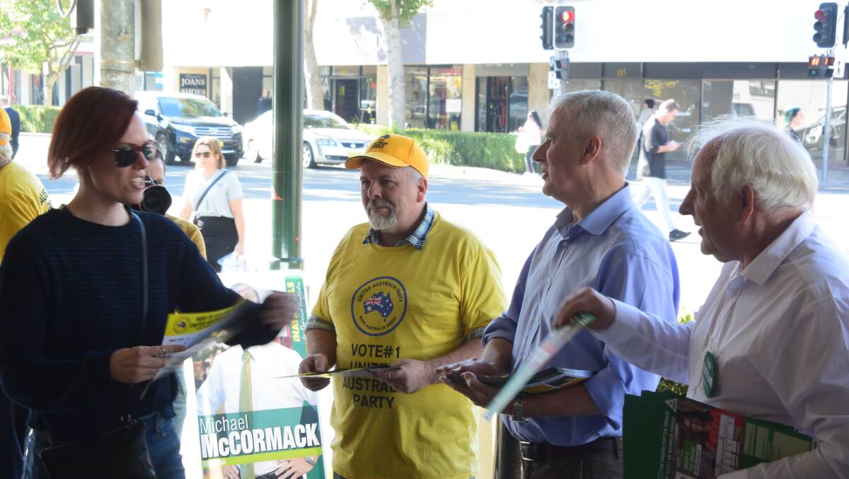 VOTE GRAB: Riverina Greens candidate Michael Bayles (right) Riverina Nationals MP Michael McCormack and United Australia Party candidate Richard Foley at Wagga's pre-poll centre on Friday. Picture: Rex Martinich