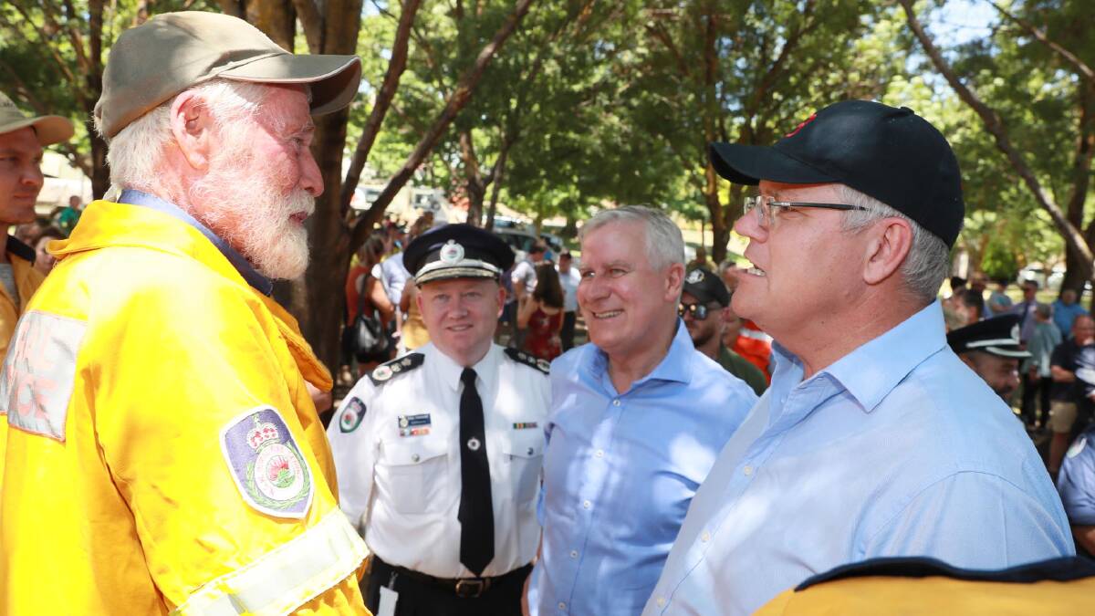 John Webb from the Glen/Mannus RFS brigade chats with Prime Minister Scott Morrison on Wednesday with RFS Commissioner Shane Fitzsimmons and Riverina MP and Deputy PM Michael McCormack looking on.