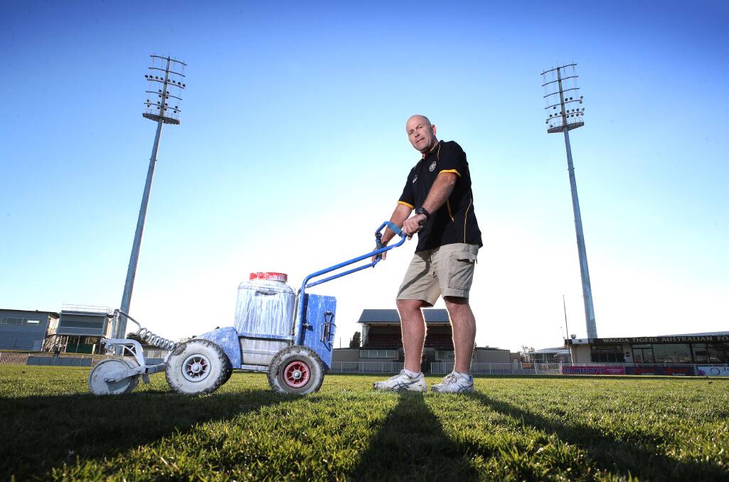 FUTURE: Wagga Tigers president Anthony Lyons marks the lines at Robertson Oval, which will be part of a $65 million Bolton Park master plan to improve central Wagga's sports precinct. Picture: Les Smith