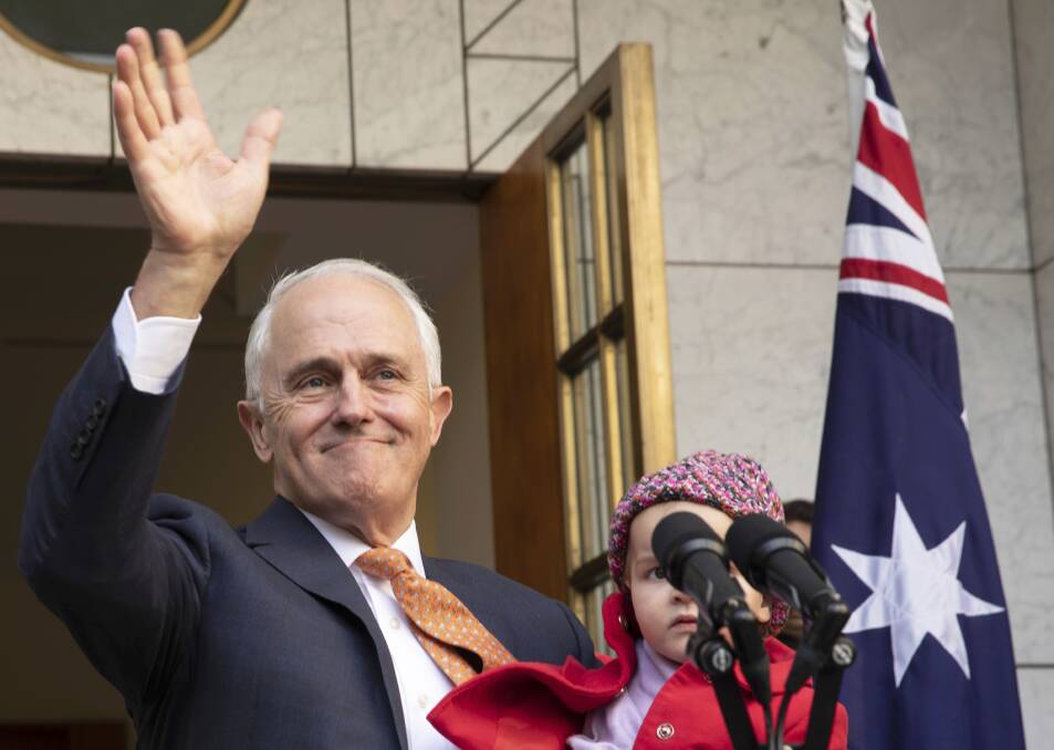 Outgoing Prime Minister Malcolm Turnbull waves while holding his granddaughter Alice during a final press conference before leaving Parliament on Friday last week. AP Photo/Andrew Taylor.