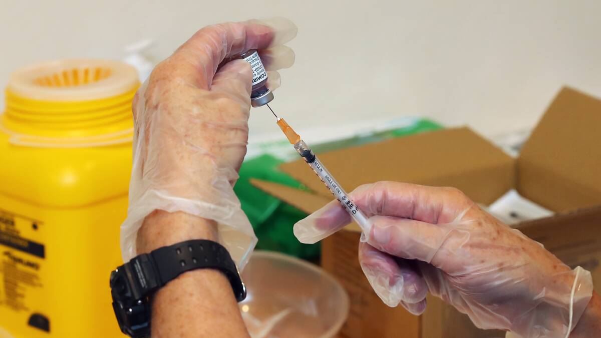 Pfizer COVID-19 vaccine doses are prepared for use at Wagga's Mary Potter Nursing Home on Friday. The NSW Government has updated it vaccine rollout to designate Wagga as a "major regional hub".