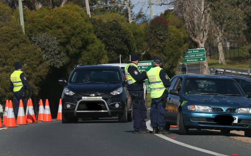Police check permits at the NSW border crossing at Hume Dam