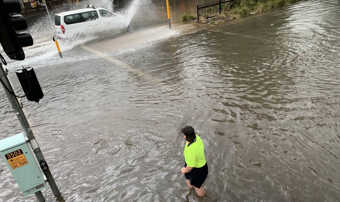SOAKED: A heavy downpour left the Forsyth Street traffic lights between the Marketplace and Sturt Mall flooded to just below the knee on Friday. Picture: Jon Tuxworth 