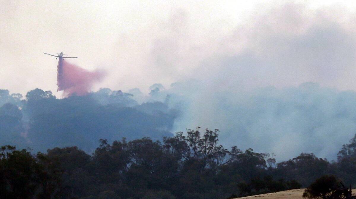 EARLY DAYS: Aircraft drop retardant on the Dunns Road fire between Tarcutta and Adelong on the second day of what would become a nearly two-month bushfire battle.