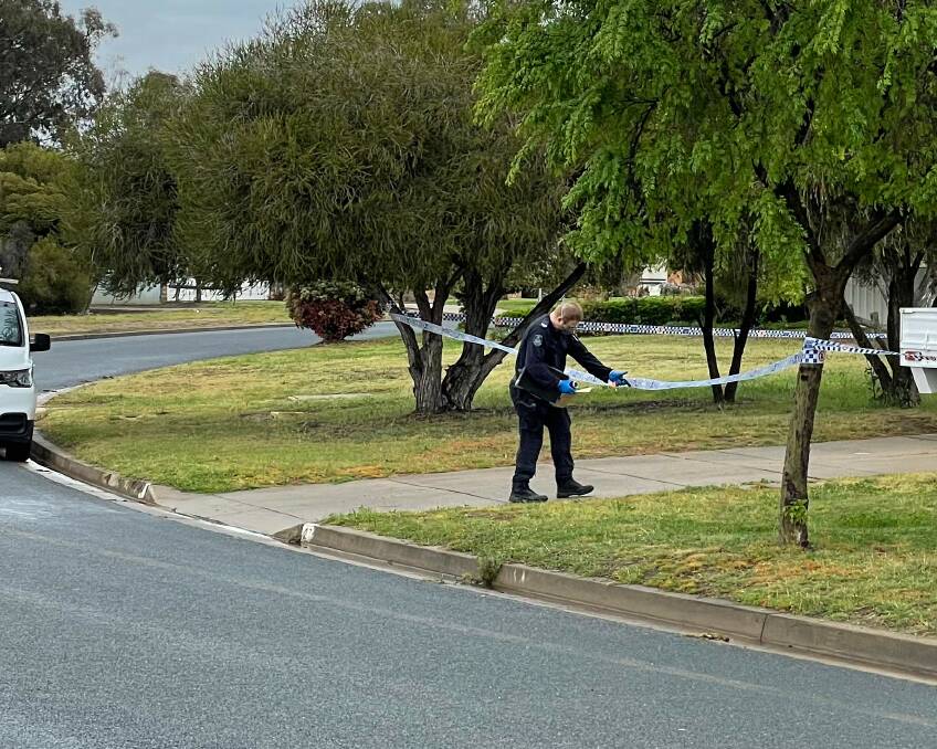 A police officer enters the crime scene at a property on Karoom Drive in Glenfield Park after a man was stabbed early Thursday morning. Picture: Rex Martinich