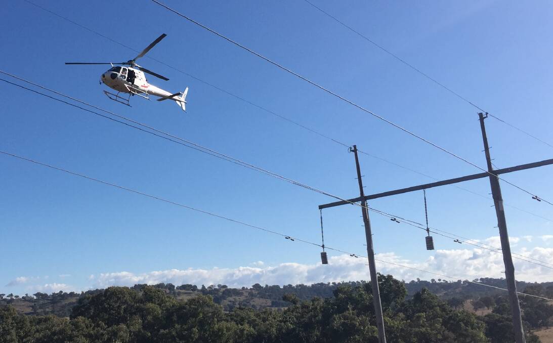 ROUTINE: A TransGrid helicopter checks high voltage power lines around Wagga in 2018 for bushfire risks and maintenance issues. Picture: Contributed